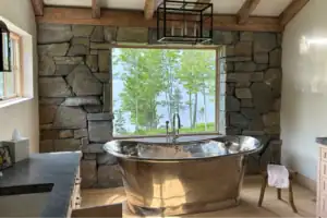 Photo of of a nice bathroom in a house with stone feature wall